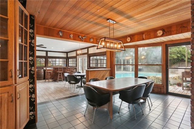 dining area with wooden ceiling and dark tile patterned flooring