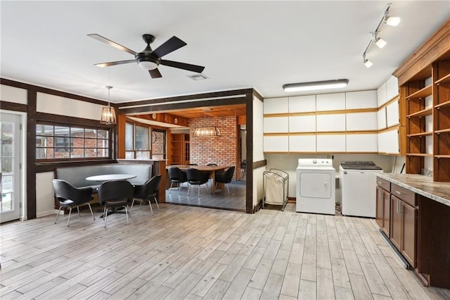 washroom featuring laundry area, light wood-type flooring, visible vents, and washer and dryer