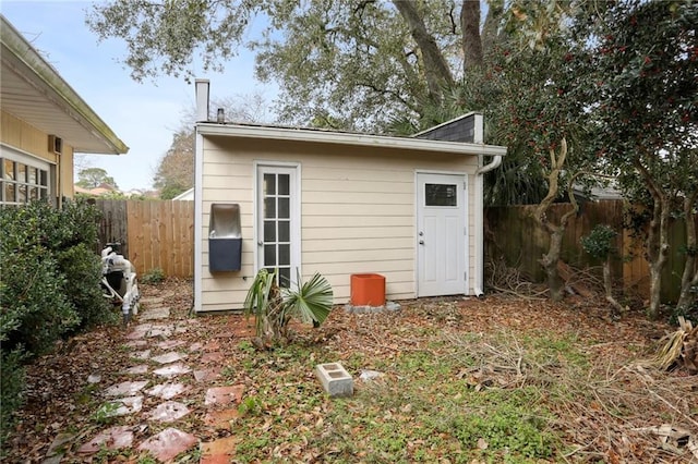 view of outbuilding with fence and an outdoor structure