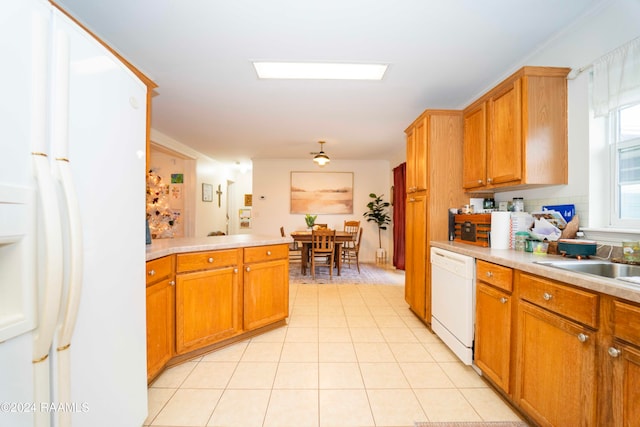 kitchen featuring kitchen peninsula, sink, light tile patterned flooring, and white appliances