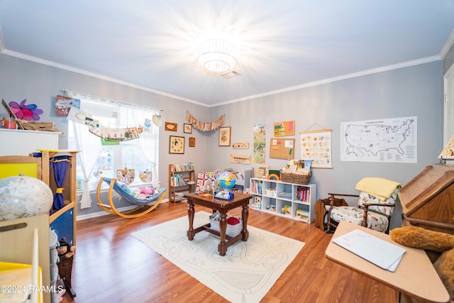 rec room featuring hardwood / wood-style flooring and ornamental molding