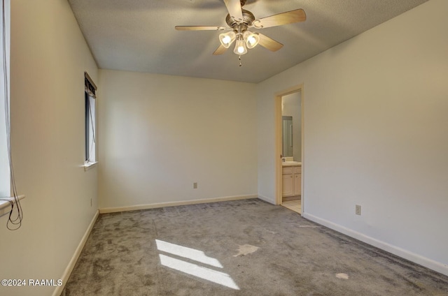 empty room with light carpet, ceiling fan, and sink