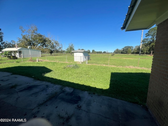 view of yard with a patio area and a rural view