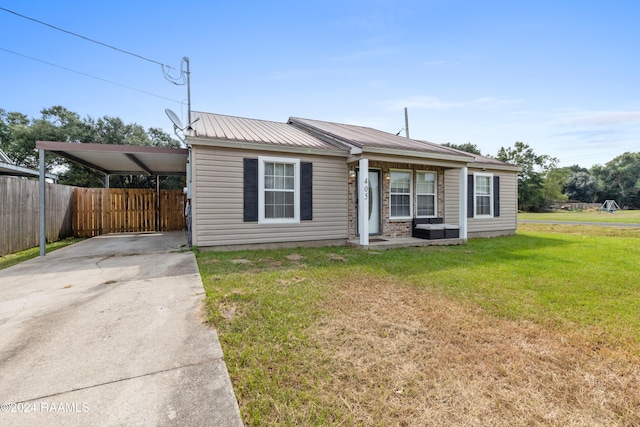 view of front of house with a carport and a front yard