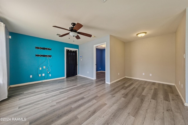 spare room with light hardwood / wood-style flooring and ceiling fan