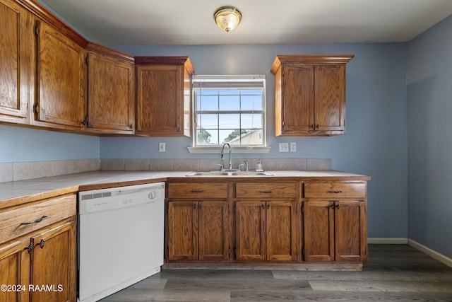 kitchen featuring white dishwasher, dark hardwood / wood-style floors, and sink