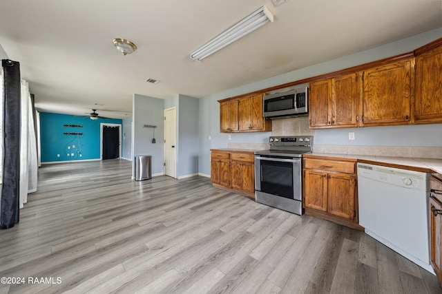 kitchen with ceiling fan, light hardwood / wood-style flooring, and stainless steel appliances