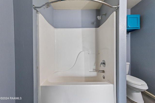 bathroom featuring hardwood / wood-style floors, toilet, and shower / bathtub combination