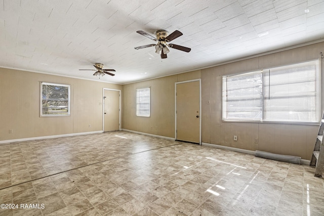 interior space featuring ceiling fan, a healthy amount of sunlight, and ornamental molding