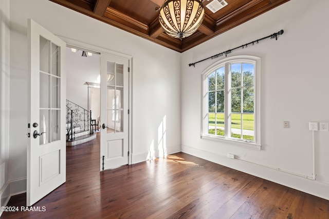 empty room with beamed ceiling, dark hardwood / wood-style flooring, coffered ceiling, and wood ceiling