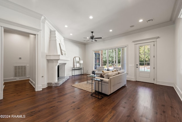 living room featuring dark hardwood / wood-style floors, ceiling fan, ornamental molding, and a high end fireplace