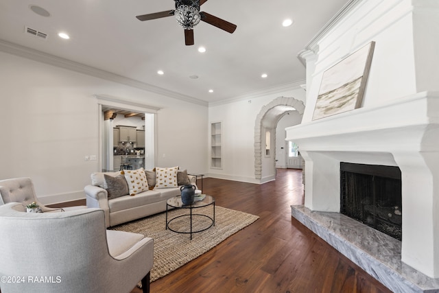 living room featuring dark hardwood / wood-style floors, ceiling fan, and ornamental molding