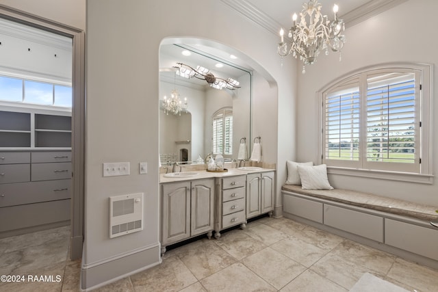 bathroom with heating unit, crown molding, vanity, and an inviting chandelier