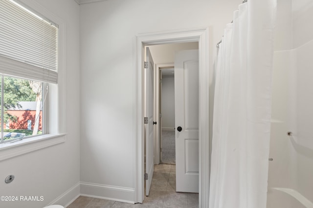 hall featuring light tile patterned floors