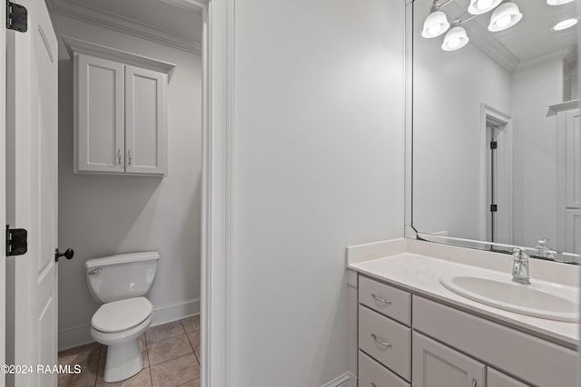 bathroom with tile patterned floors, vanity, toilet, and ornamental molding