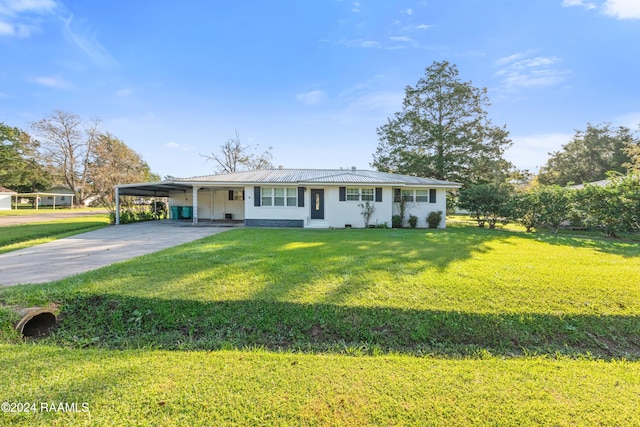 ranch-style house featuring a front yard and a carport