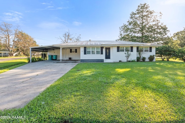 ranch-style home with a front yard and a carport