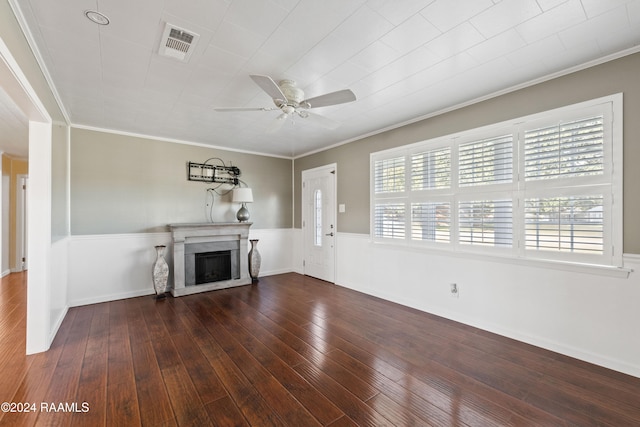 unfurnished living room featuring dark hardwood / wood-style floors, ceiling fan, and ornamental molding