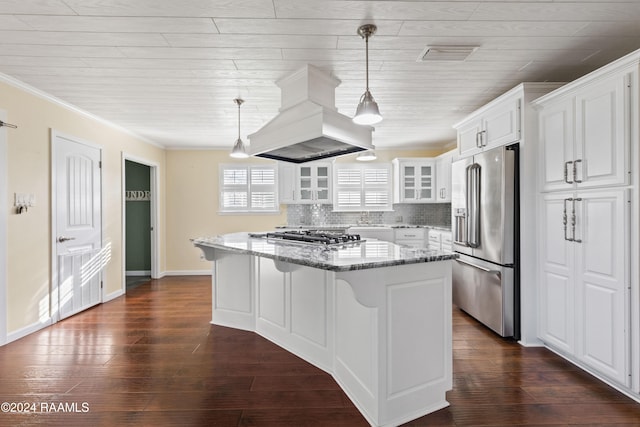 kitchen featuring stainless steel appliances, white cabinetry, dark stone countertops, and custom exhaust hood