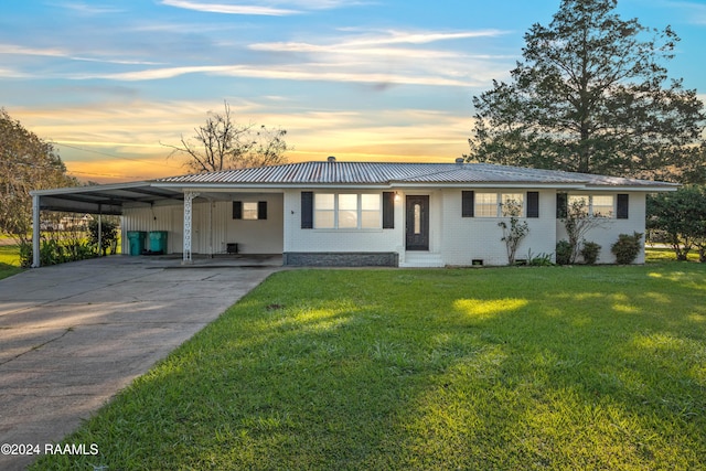 single story home with a carport and a yard