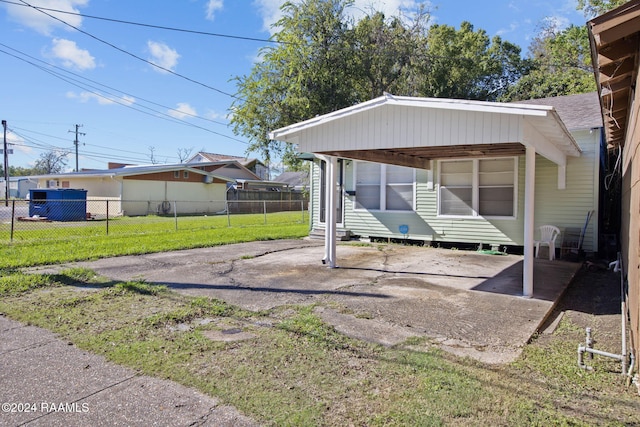 exterior space featuring a carport and a lawn