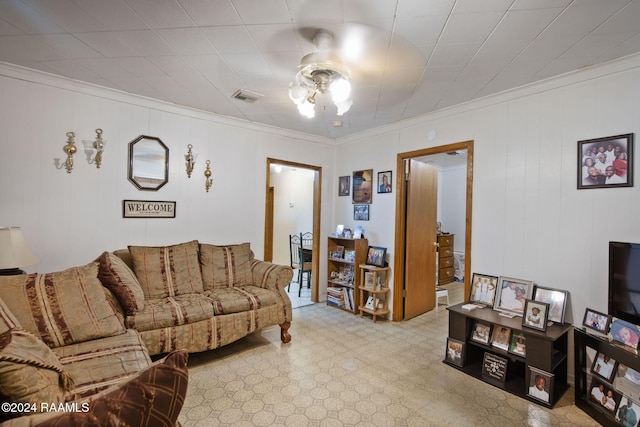 living room featuring ceiling fan and ornamental molding