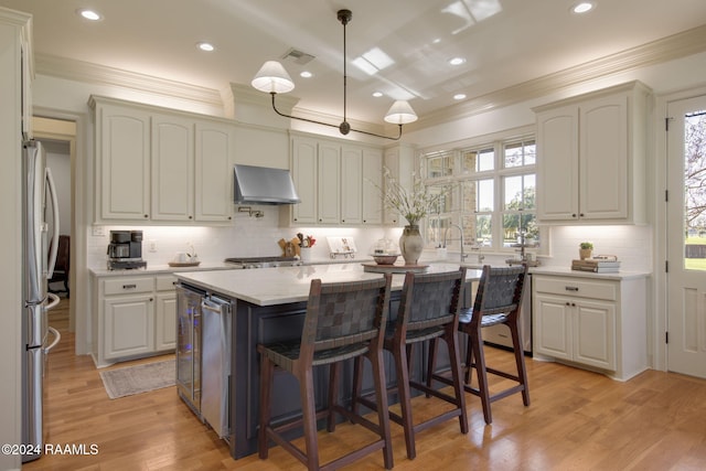 kitchen with stainless steel fridge, extractor fan, light hardwood / wood-style flooring, white cabinets, and a kitchen island