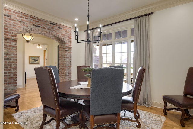 dining room with crown molding, light hardwood / wood-style flooring, and ceiling fan with notable chandelier