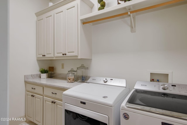 laundry room with cabinets and washing machine and dryer