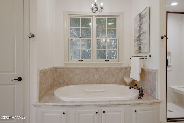 bathroom featuring a chandelier and independent shower and bath