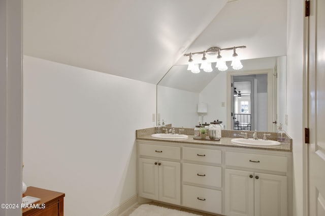 bathroom with vanity, ceiling fan, and lofted ceiling