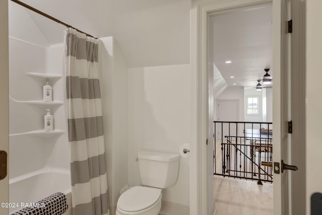 bathroom featuring ceiling fan, shower / tub combo, vaulted ceiling, and toilet