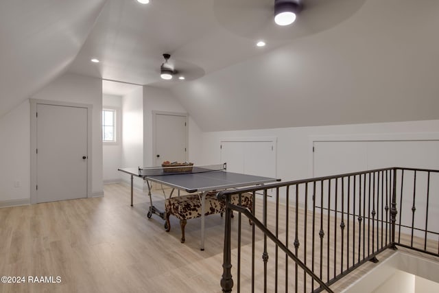 recreation room featuring light hardwood / wood-style flooring, ceiling fan, and lofted ceiling