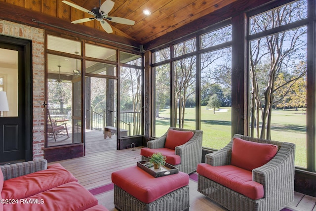 sunroom / solarium featuring ceiling fan, wooden ceiling, and vaulted ceiling