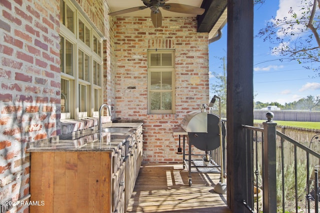 balcony featuring ceiling fan and sink