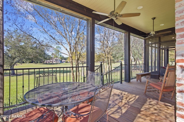 wooden deck with a yard and ceiling fan