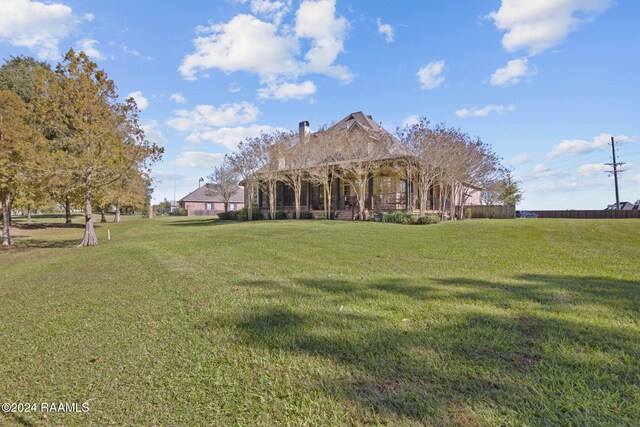 312 Shinnecock Hills Dr, Broussard, LA 70518 - back of property featuring a chimney and a yard