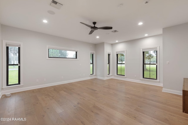 empty room with light hardwood / wood-style floors and ceiling fan