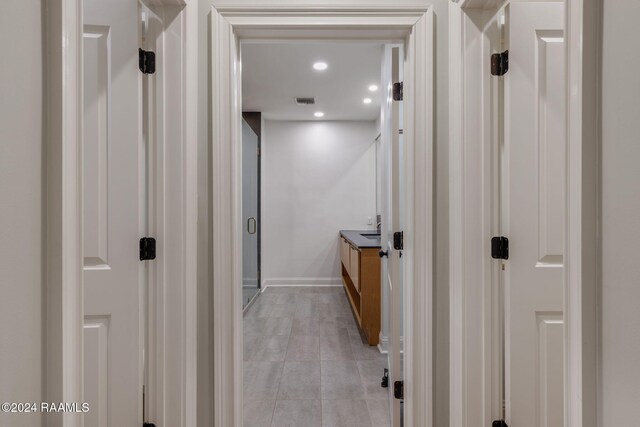 corridor featuring light tile patterned floors