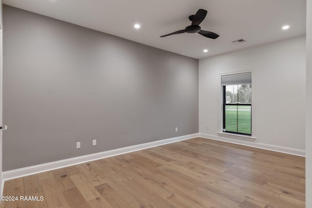 empty room with ceiling fan and light hardwood / wood-style floors