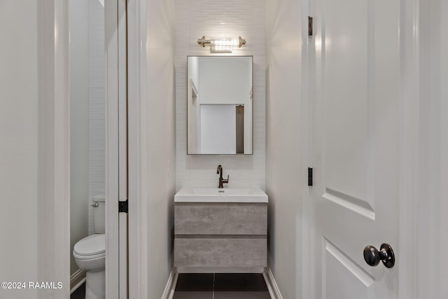 bathroom with tile patterned floors, vanity, and toilet