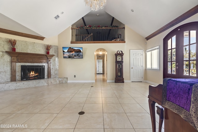 1412 US Highway 167, Abbeville, LA 70510 - living area with tile patterned floors, baseboards, arched walkways, high vaulted ceiling, and a fireplace