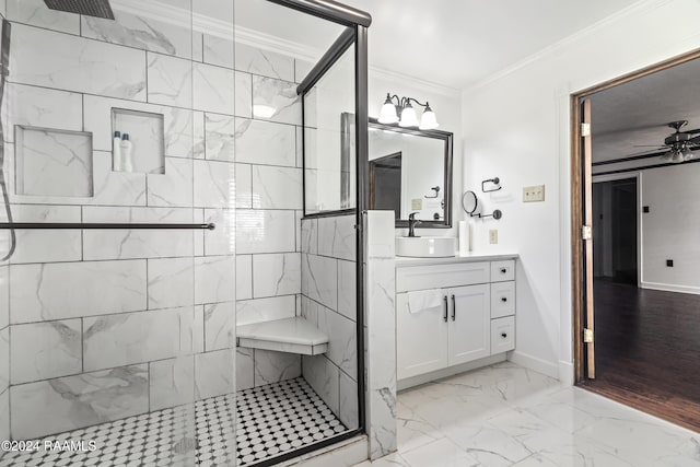 bathroom featuring ceiling fan, an enclosed shower, ornamental molding, and vanity