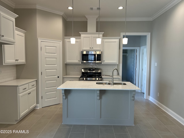 kitchen with white cabinetry, appliances with stainless steel finishes, sink, and decorative light fixtures