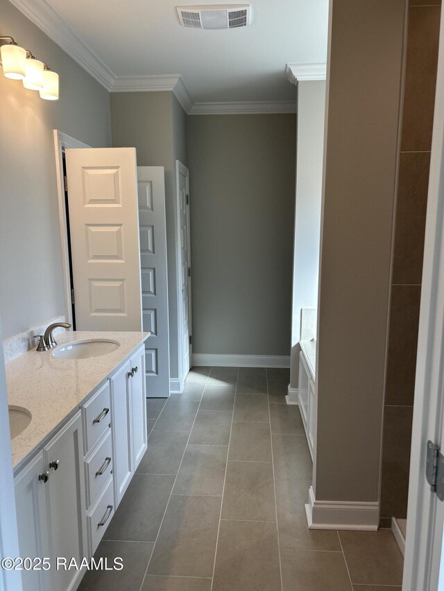 bathroom featuring vanity, a washtub, crown molding, and tile patterned flooring