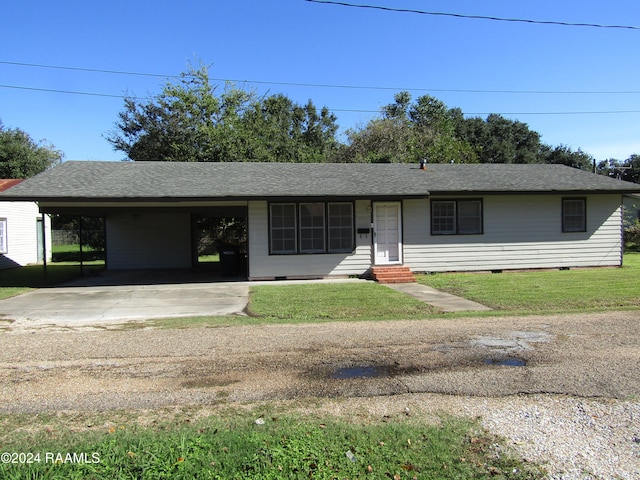 ranch-style house with a front lawn and a carport