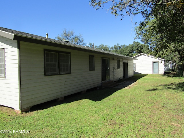 rear view of house with a lawn