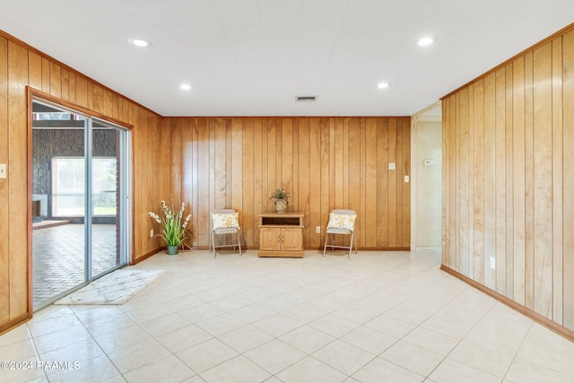 unfurnished room with wood walls