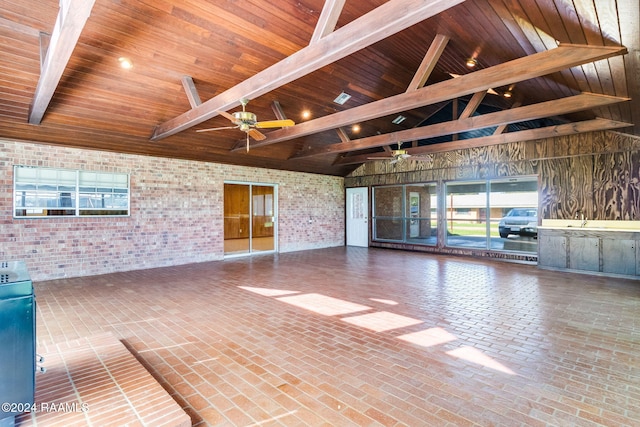 interior space featuring beamed ceiling, wooden ceiling, and brick wall