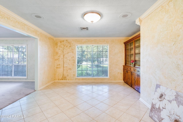 unfurnished dining area featuring light tile patterned floors, a wealth of natural light, and ornamental molding